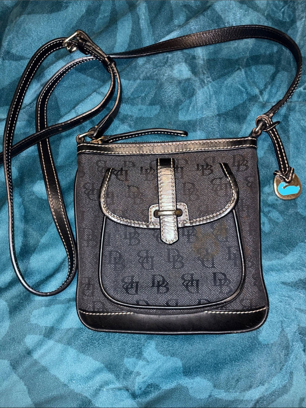 Dooney & Bourke Denim Crossbody with Front Flap and Buckle and hang tag.